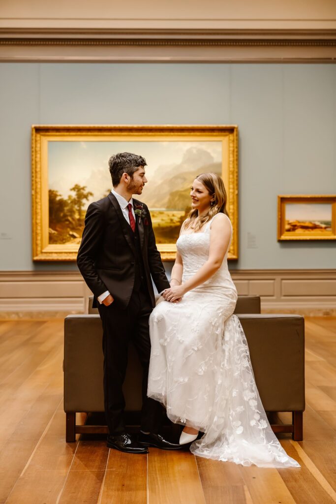elopement couple sitting in front of artwork at the national gallery of art in dc