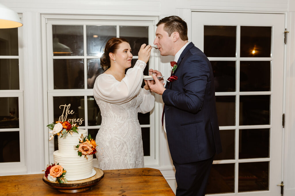 elopement couple cutting their cake during their vrbo wedding reception