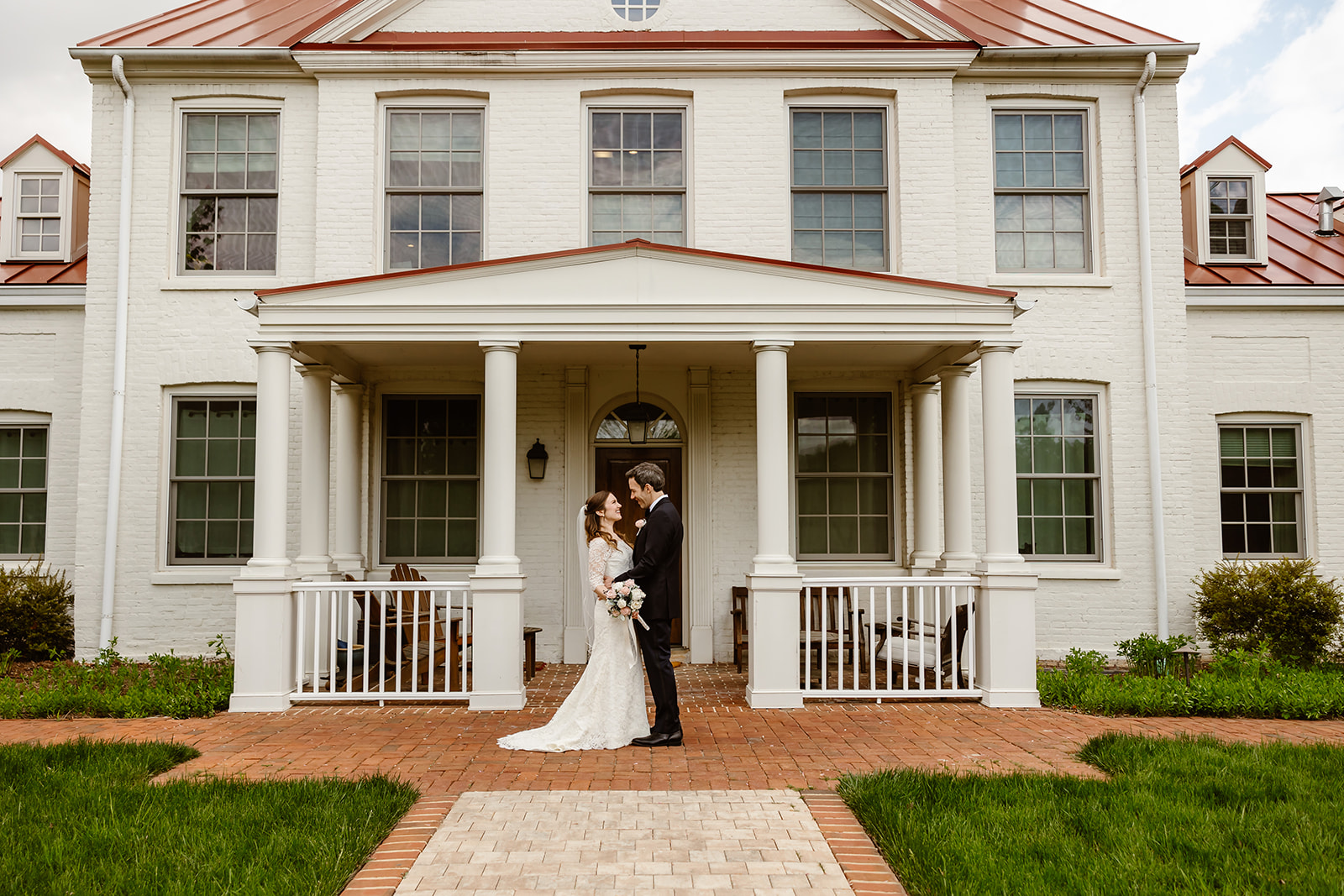 elopement couple hugging in front of their DC home