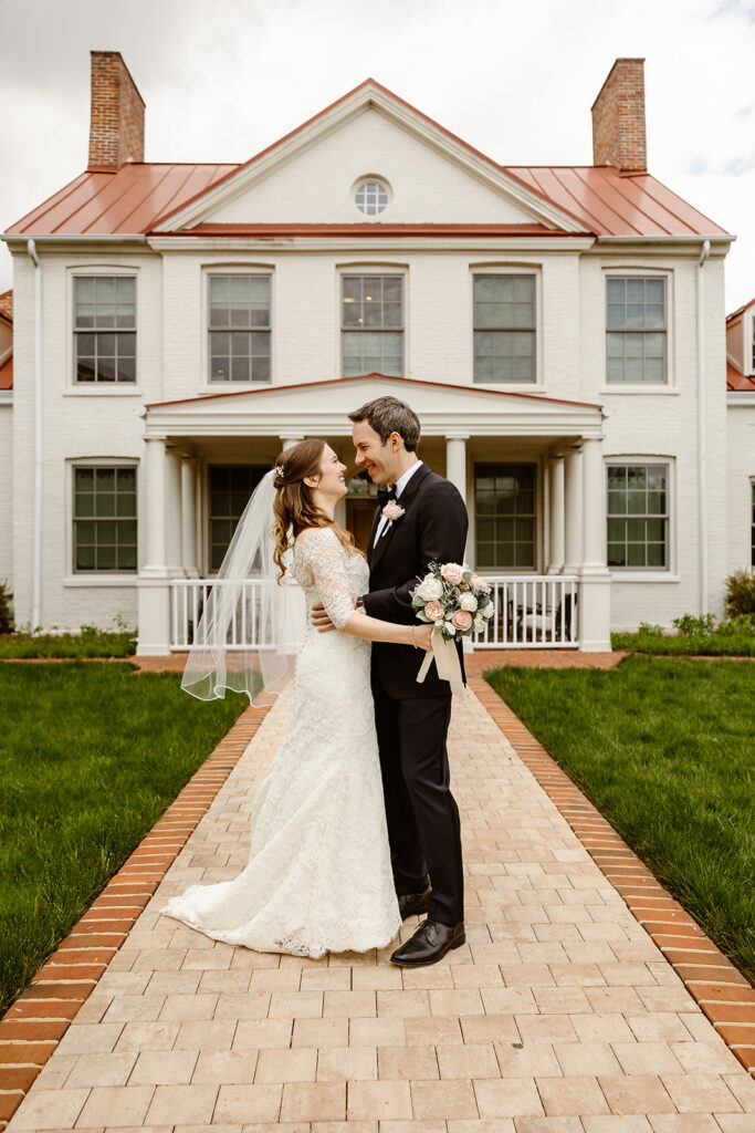 elopement couple hugging in front of their DC home