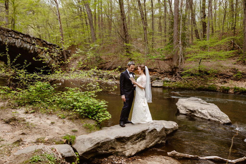 elopement couple exchanging private vows by the water at rock creek park