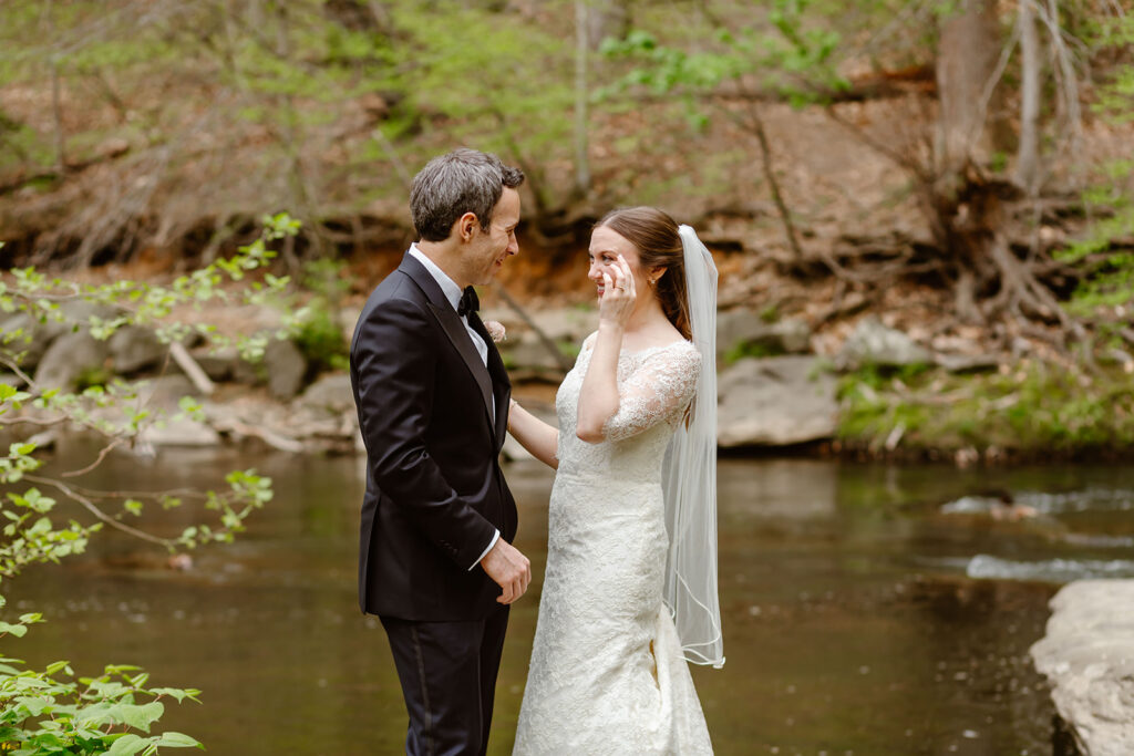 elopement couple exchanging private vows by the water at rock creek park