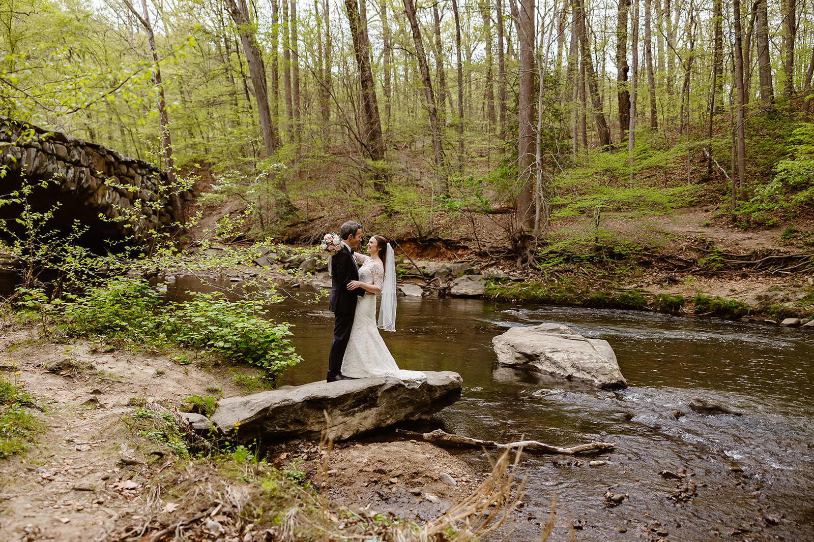 elopement couple exchanging private vows by the water at rock creek park